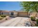 Inviting home exterior with a two-car garage, blue shutter, and drought-resistant landscaping at 7238 N 126Th Ln, Glendale, AZ 85307