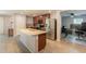 Spacious kitchen featuring granite island, stainless steel fridge, and tile flooring at 7238 N 126Th Ln, Glendale, AZ 85307