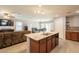 Open kitchen layout with granite island offering space for dining and entertaining at 7238 N 126Th Ln, Glendale, AZ 85307