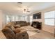 Open-concept living room showcasing tile flooring, recessed lighting, and comfortable seating at 7238 N 126Th Ln, Glendale, AZ 85307