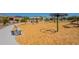 Community playground with swings, slides, and a merry-go-round that offers fun for all ages at 7238 N 126Th Ln, Glendale, AZ 85307