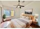 Bright bedroom with a modern ceiling fan, natural wood furniture, and plenty of natural light at 7801 N 44Th Dr # 1180, Glendale, AZ 85301