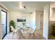 Stylish dining area with modern lighting, glass table, white chairs, and sliding glass door at 7801 N 44Th Dr # 1180, Glendale, AZ 85301