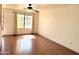 Bright living room boasts hardwood floors, ample natural light, ceiling fan, and neutral walls at 7801 N 44Th Dr # 1180, Glendale, AZ 85301