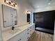 Modern bathroom featuring dual sinks, white vanities, and a sleek tile shower at 81 E Smoke Tree Rd, Gilbert, AZ 85296