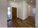 Inviting entryway with wood-look floors, white walls, and bright natural light from the sidelight window at 81 E Smoke Tree Rd, Gilbert, AZ 85296