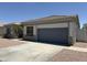 A single-story home featuring a gray 2 car garage and desert landscaping at 81 E Smoke Tree Rd, Gilbert, AZ 85296