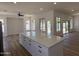 A bright, open floorplan with a large kitchen island and access to the backyard and pool at 81 E Smoke Tree Rd, Gilbert, AZ 85296