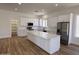 A stunning renovated kitchen featuring stainless appliances, white cabinets and a large island at 81 E Smoke Tree Rd, Gilbert, AZ 85296