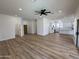 Spacious living room featuring wood floors and a seamless flow into the kitchen at 81 E Smoke Tree Rd, Gilbert, AZ 85296