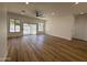 Bright living room with wood flooring and sliding glass door with pool view at 81 E Smoke Tree Rd, Gilbert, AZ 85296