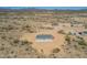This aerial view showcases a modern desert home and its beautiful arid surroundings at 873 N Windy Meadow Ln, Maricopa, AZ 85139