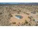 This aerial view showcases a desert home featuring a spacious lot and tranquil setting at 873 N Windy Meadow Ln, Maricopa, AZ 85139
