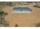Aerial view showcasing back patio and surrounding desert landscape at 873 N Windy Meadow Ln, Maricopa, AZ 85139