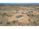 A beautiful home set in a rural desert community is showcased in this aerial shot at 873 N Windy Meadow Ln, Maricopa, AZ 85139