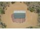 Aerial view home showcasing concrete patio with desert landscaping and gravel at 873 N Windy Meadow Ln, Maricopa, AZ 85139
