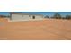Spacious backyard of the house, featuring desert landscaping, and large patio at 873 N Windy Meadow Ln, Maricopa, AZ 85139