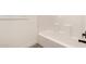 Bathroom with a bright white tub and black hardware at 873 N Windy Meadow Ln, Maricopa, AZ 85139