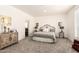 Bedroom featuring carpet flooring, a decorative bed frame, and ample natural lighting at 873 N Windy Meadow Ln, Maricopa, AZ 85139