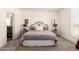 Comfortable bedroom with carpet flooring, stylish bed frame, and ample natural light at 873 N Windy Meadow Ln, Maricopa, AZ 85139