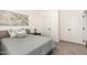 Serene bedroom with white trim, neutral decor, and a plush carpet at 873 N Windy Meadow Ln, Maricopa, AZ 85139