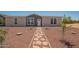 Charming single-Gathering home with rock landscaping and a walkway leading to the front door at 873 N Windy Meadow Ln, Maricopa, AZ 85139