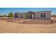 Charming single-Gathering home with rock landscaping and a walkway leading to the front door at 873 N Windy Meadow Ln, Maricopa, AZ 85139