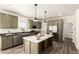 Modern kitchen featuring stainless steel appliances, a central island, and stylish pendant lighting at 873 N Windy Meadow Ln, Maricopa, AZ 85139