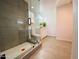 Contemporary bathroom showcases a glass walk-in shower with a tiled base, white vanity, and great lighting at 9053 N 53Rd Ave, Glendale, AZ 85302