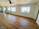 Bright bedroom features new floors, a ceiling fan, and mirrored closet doors for a modern look at 9053 N 53Rd Ave, Glendale, AZ 85302
