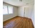Clean bedroom with new floors and a large window, offering ample natural light and space at 9053 N 53Rd Ave, Glendale, AZ 85302