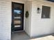 Charming front porch with a modern multi-paneled front door and decorative wreath at 9053 N 53Rd Ave, Glendale, AZ 85302