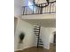 Bright living area with a unique spiral staircase and modern chandelier for a stylish living space at 9053 N 53Rd Ave, Glendale, AZ 85302