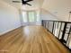 Bright loft area with large windows, wood flooring, and modern ceiling fan at 9053 N 53Rd Ave, Glendale, AZ 85302