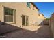 Gravel back yard featuring a sliding glass door and partial shade at 909 E Agua Fria Ln, Avondale, AZ 85323