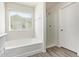Bright bathroom features a bathtub, shower, and window with natural lighting at 909 E Agua Fria Ln, Avondale, AZ 85323