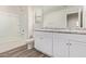 Bathroom featuring double sinks, white cabinets, and a shower/tub combo at 909 E Agua Fria Ln, Avondale, AZ 85323