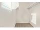 Walk-in closet features carpet, shelving, and natural light, offering practical storage solutions at 909 E Agua Fria Ln, Avondale, AZ 85323