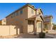 Well-maintained two-story home with desert landscaping and covered porch at 909 E Agua Fria Ln, Avondale, AZ 85323
