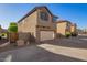 Two story home featuring a two car garage, desert landscaping, and a concrete driveway at 909 E Agua Fria Ln, Avondale, AZ 85323