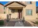 Inviting front porch with stylish supports and desert landscaping at 909 E Agua Fria Ln, Avondale, AZ 85323