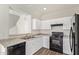 Bright kitchen with white cabinets, stainless steel sink, and modern appliances is perfect for cooking at 909 E Agua Fria Ln, Avondale, AZ 85323