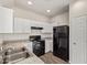 Well-lit kitchen features white cabinets, modern appliances, and sleek countertops for a clean aesthetic at 909 E Agua Fria Ln, Avondale, AZ 85323