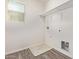 Utility room featuring washer hookups, a window for natural light, and storage shelving at 909 E Agua Fria Ln, Avondale, AZ 85323