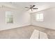 Large bedroom features carpet, ceiling fan, multiple windows, and natural lighting at 909 E Agua Fria Ln, Avondale, AZ 85323