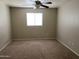 A well lit bedroom with neutral walls and carpet and ceiling fan at 1340 N Recker Rd # 154, Mesa, AZ 85205
