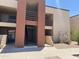 A clean, multi-level exterior view of the apartment complex featuring pedestrian access and well-maintained landscaping at 1340 N Recker Rd # 154, Mesa, AZ 85205
