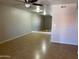 A spacious living room featuring neutral walls, tile floors, ceiling fan and an accent mirror wall at 1340 N Recker Rd # 154, Mesa, AZ 85205