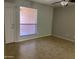 Bright living room featuring tile floors, ceiling fan and a large window with natural light at 1340 N Recker Rd # 154, Mesa, AZ 85205