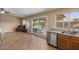 Kitchen and living room view showcasing sliding glass doors, stainless steel appliances, and tile floors at 1415 W Michigan Ave, Phoenix, AZ 85023